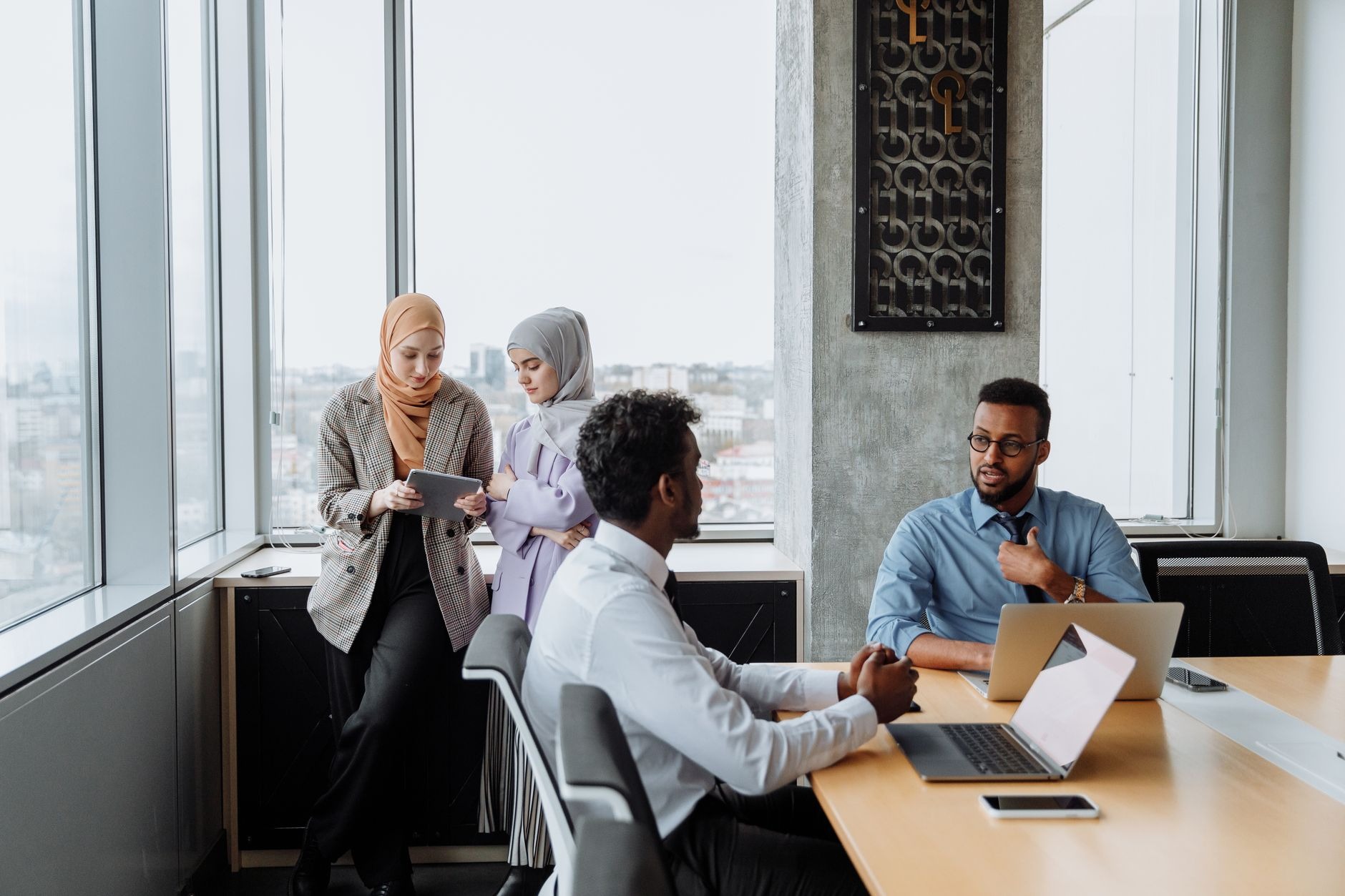 diverse team collaborating with AI in a modern office